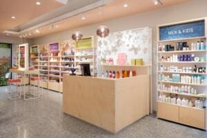 Negozio di Bioprofumeria in stile nordico con banco cassa e arredi in legno chiaro